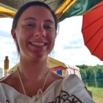Courtesan Ginevra Fiammetta di Silvestri at the Pennsic Knowne World Courtesans Social on August 8th, 2016 Closeup photo of a woman in ancient Roman clothing under a tent outdoors